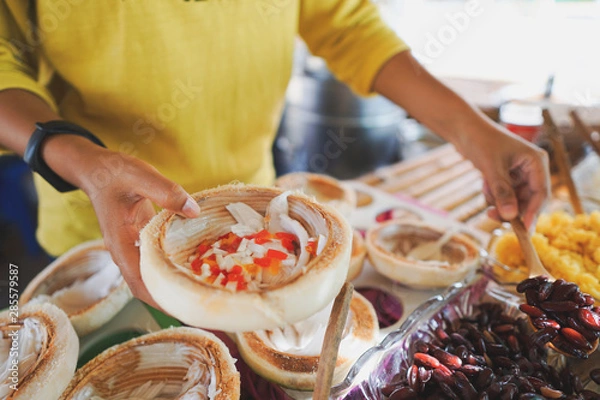 Fototapeta Ice cream made from coconut Put in a container from coconut. Looks good.
