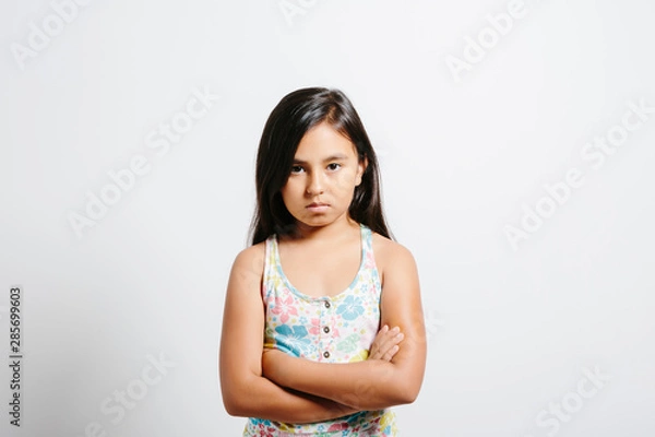 Obraz Young girl looking upset over white background.