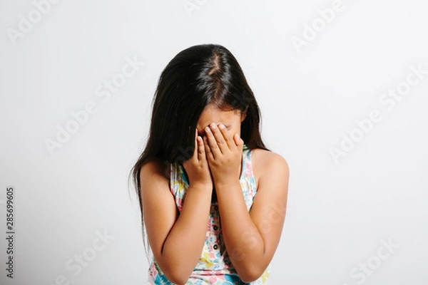 Obraz Young girl crying over white background.