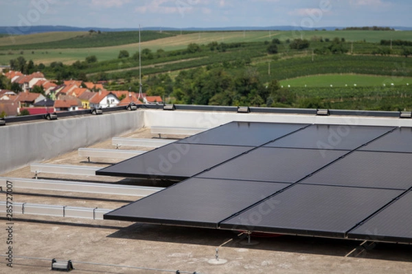 Fototapeta Solar panels at the top of the building. Solar modules on a flat roof.