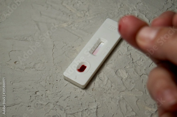 Fototapeta HIV self-test finger with a drop of blood. Hiv test express.