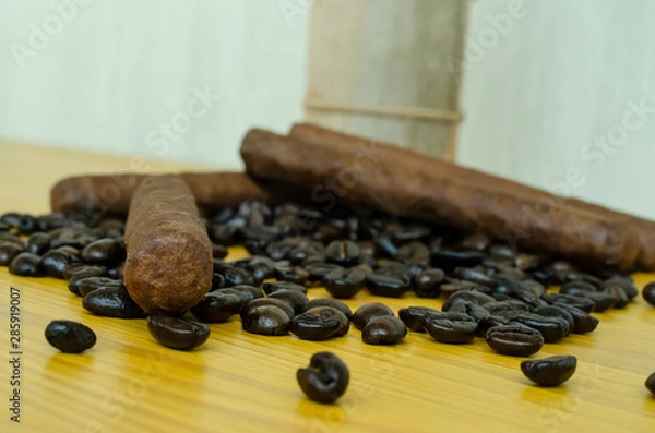 Fototapeta coffee beans on wooden table with cigars