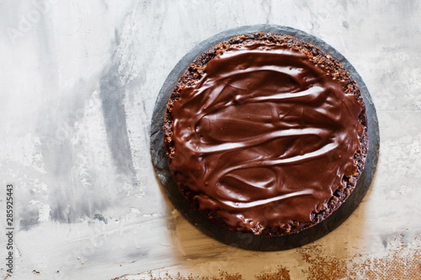 Fototapeta Chocolate brownie cake with ganashe topping on gray background