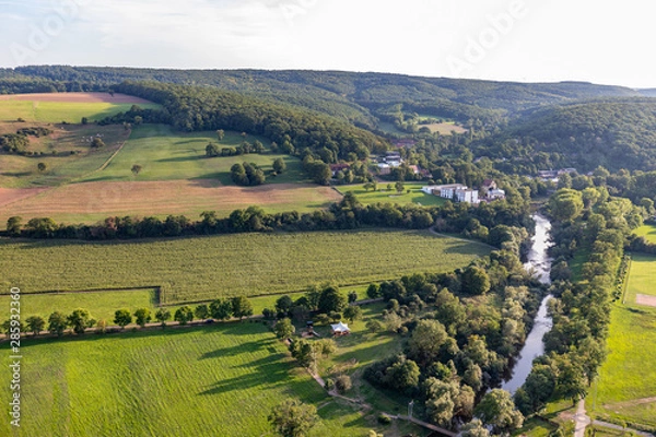 Obraz Aerial view at a landscape in Germany, Rhineland Palatinate near Bad Sobernheim with the river Nahe, meadow, farmland, forest and mountain range in the background
