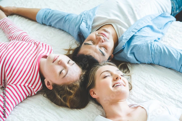 Fototapeta Top view of family cute looking , happiness looking at the camera and smiling while lying on the bed at home