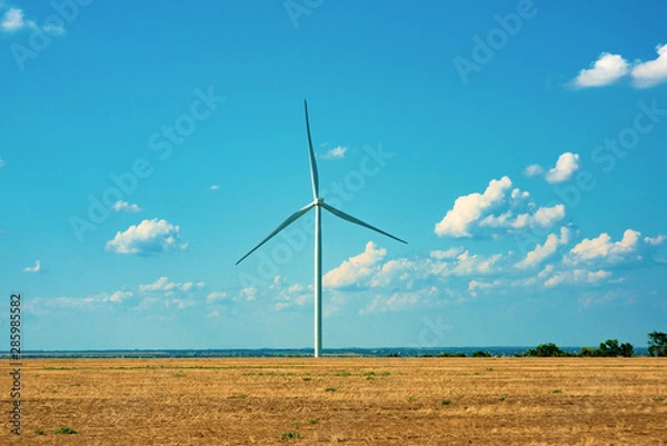 Fototapeta Wind generators with turbine engines and large blades. Electricity air generators are placed in the field.
