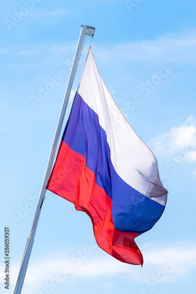 Obraz Russian flag on blue sky background.