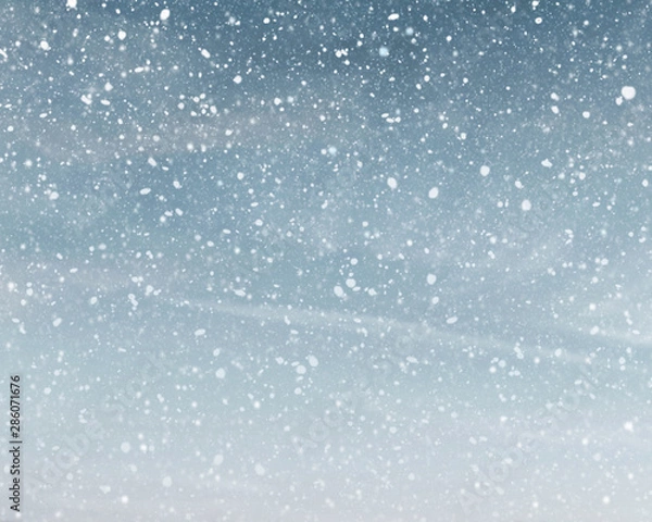 Obraz Snowfall in cloudy blue sky