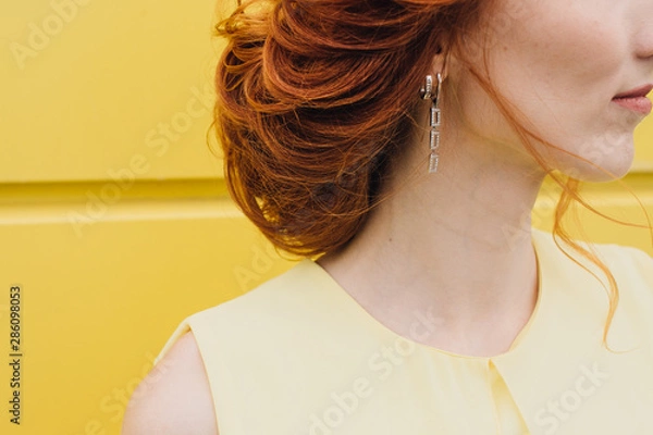 Obraz close-up of an earring on a refined redhead girl