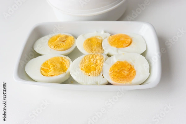Fototapeta Sliced boiled eggs on white plate, Ready to eat.