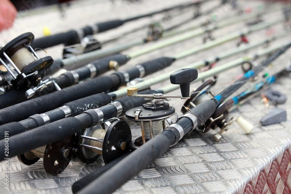 Fototapeta Collection of sea boat fishing rods and reels on a charter boat