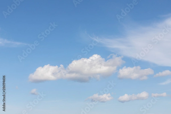 Fototapeta Blue sky with white clouds. In the sky you can see fluffy clouds and feather clouds. Background with free space and empty place.