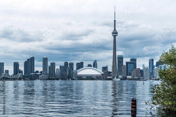 Fototapeta Waterfront view of Toronto City Skyscrapers along with CN Tower, Scarborough districts in summer, a view from Toronto Central Island, Toronto, Ontario, Canada