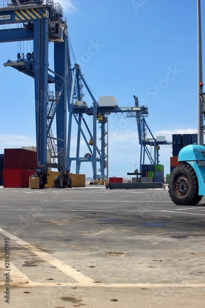 Fototapeta Gantry Crane Rail Mounted handling shipping containers in the harbour area