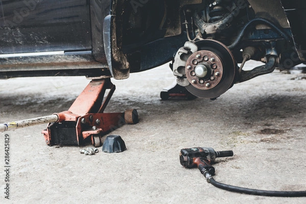 Obraz The car is waiting to change to a new wheel  with Impact Wrench