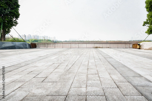 Fototapeta Empty floor square and playground ferris wheel in the city park