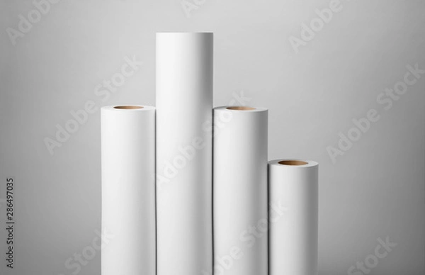 Obraz Blank white paper rolls isolated on gray background. Mockup paper for magazines, catalogs or newspapers isolated on gray backdrop, Printing house theme or wrapping paper for presents