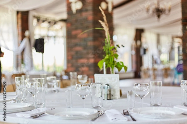 Fototapeta Table set for an event party or wedding reception.