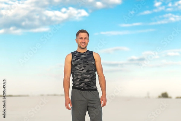 Obraz Portrait fit man in white sand desert