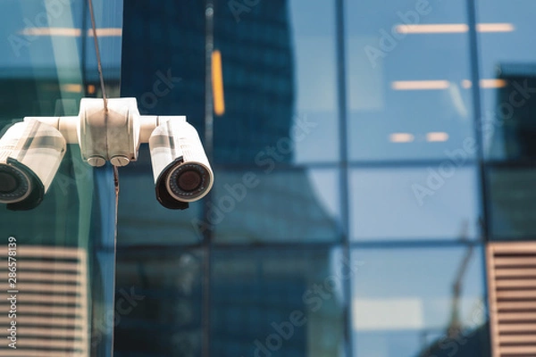 Fototapeta Security surveillance system at the entrance to a modern office building. Two cameras of video surveillance.