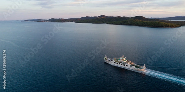 Fototapeta Aerial view of car ferry with Ugljan island in background at dusk, Croatia