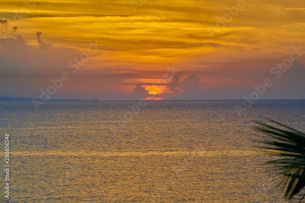 Obraz Orange and blue sunset on the beach in the tropics