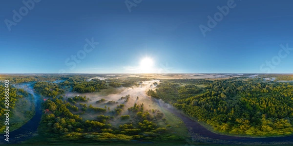 Obraz 360-degree panoramic aerial view of the field, forest and river covered with a thick layer of morning fog
