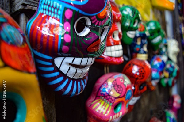 Obraz Many hand-painted, brightly-colored Dia de los Muertos skull souvenirs
