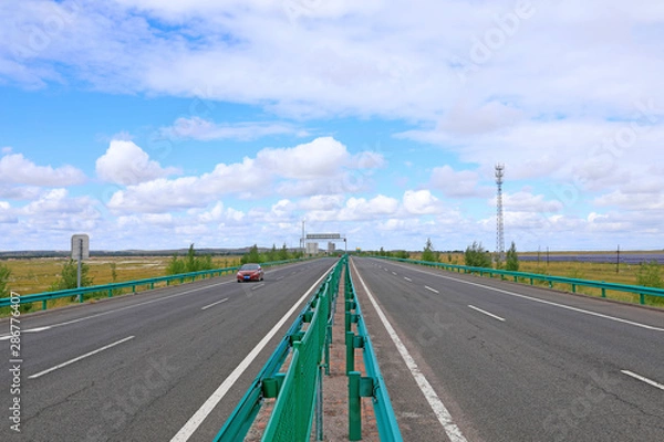 Fototapeta Beautiful highway, under the blue sky and white clouds