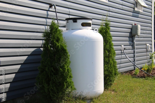 Fototapeta A large propane tank on the side of a house