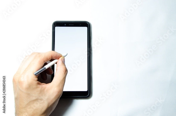 Fototapeta Electronic signature by a male hand on a smartphone with a black frame on a white background close, top, side