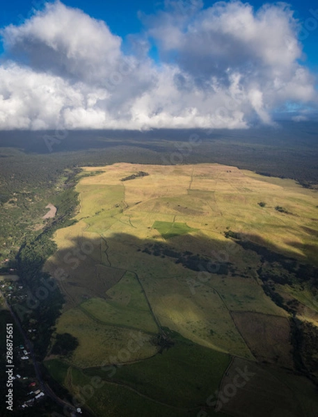 Fototapeta Aerial view between Waiohinu and Naalehu looking down on farms make abstract patterns on the big island of hawaii
