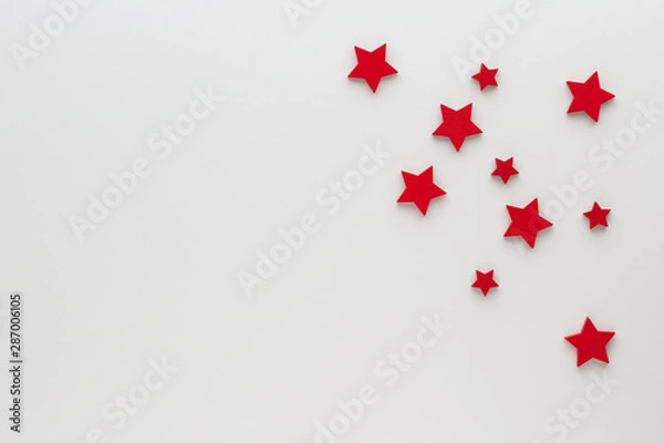 Fototapeta Christmas composition. Background with red stars top view background with copy space for your text. Flat lay.