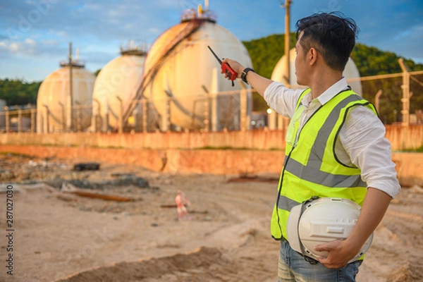 Fototapeta Engineer in the oil and natural gas field, pipeline, refinery.
