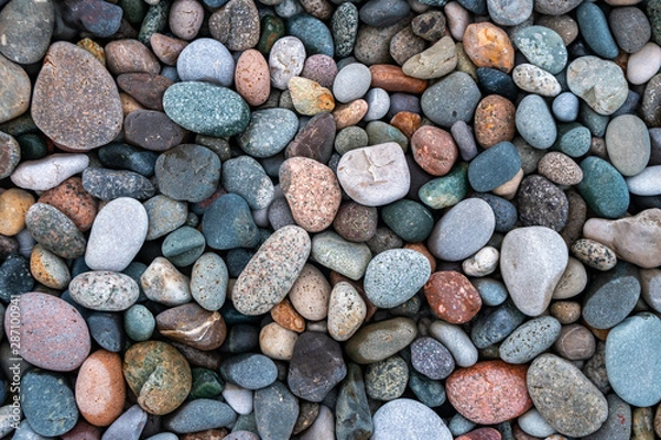 Fototapeta Close up of rounded and polished beach rocks.