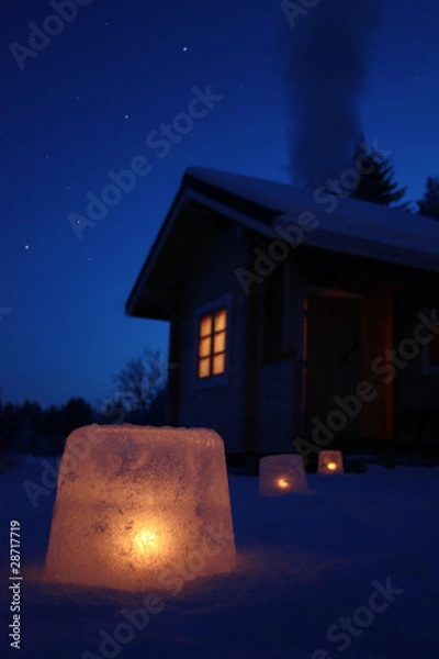 Obraz Log cabin in winter night with ice lantern decoration