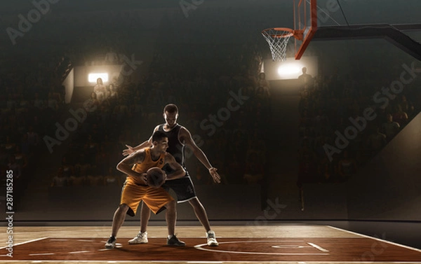 Obraz Basketball players fight for a ball near the rim