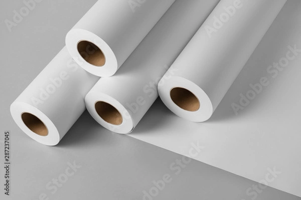 Obraz Blank white paper rolls isolated on gray background. Mockup paper for magazines, catalogs or newspapers isolated on gray backdrop, Printing house theme or wrapping paper for presents