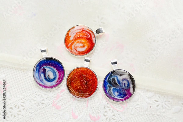 Fototapeta Create galaxy drink coasters using resin, glitter and pigment powders, handmade items. Suitable for keychains, necklace and pendant.