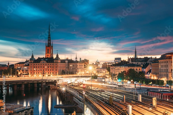 Fototapeta Stockholm, Sweden. Scenic View Of Stockholm Skyline At Summer Evening. Famous Popular Destination Scenic Place. Riddarholm Church And Subway Railway