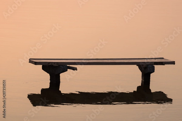 Obraz Bench in snset reflaction