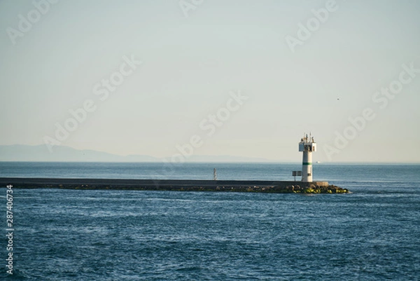 Fototapeta blue waves and lighthouse background