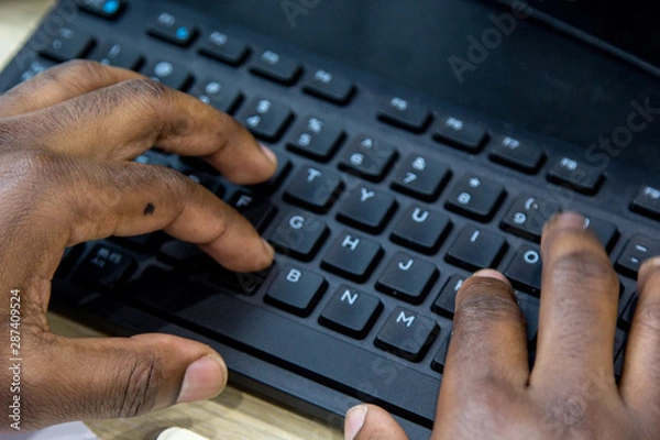 Fototapeta African man hands typing on keyboard