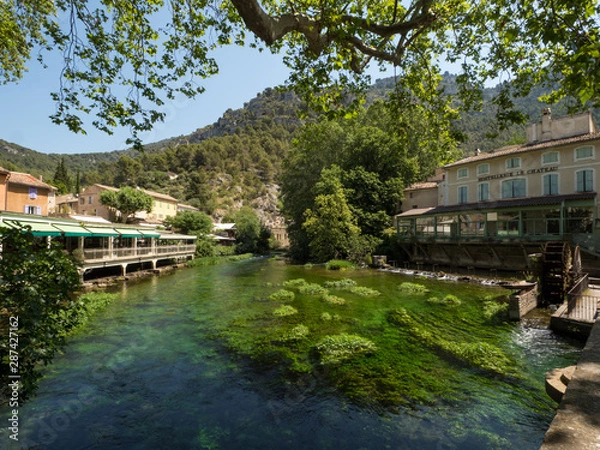 Fototapeta France, july 2019: Fontaine-de-Vaucluse, a small typical town in Provence. Beautiful village, with view on roof and landscape, small cafe and restaurants.