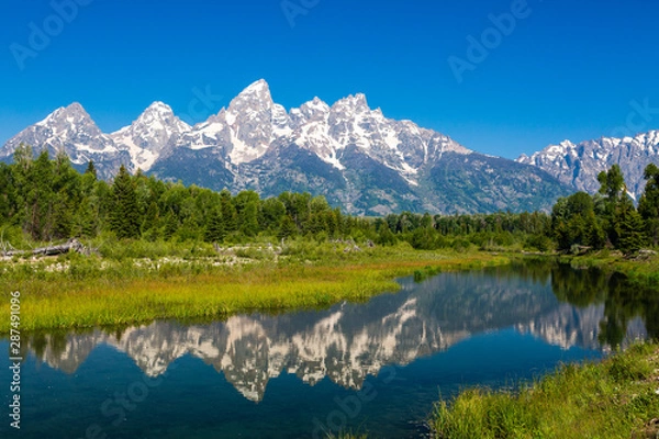 Obraz The Tetons reflected in the Snake River at Schwabacher Landing in Grand Teton National Park, Wyoming