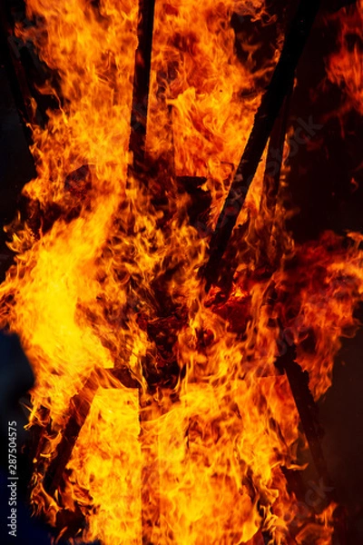 Fototapeta Flame of fire from a burning house as an abstract background
