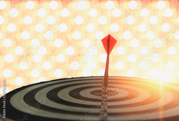 Fototapeta Dart with arrows on the bokeh blur background comparing to the number one target marketing concept and success.