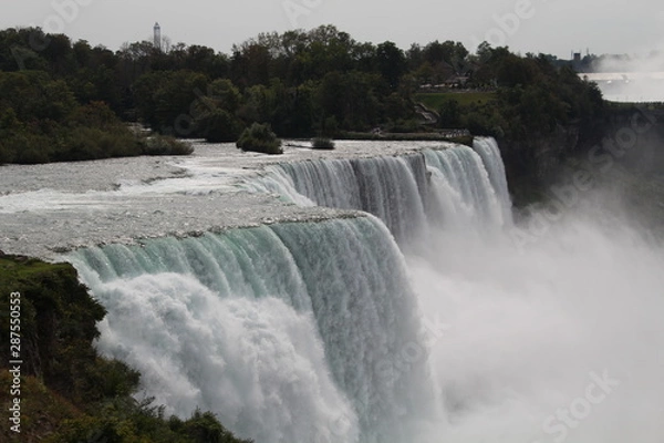 Fototapeta Close up of Niagara falls viewed from usa in the day with the bright sun, with a lot of mist