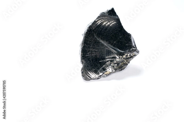 Fototapeta A black rock also called healing stone shungite, which consists mainly of carbon was photographed here in top quality.