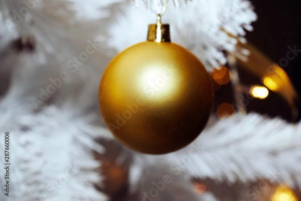 Fototapeta Christmas tree toy on the background of a white Christmas tree